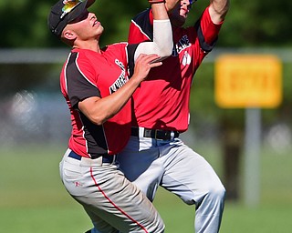 STRUTHERS, OHIO - JULY 7, 2018: Knightline' Colton Stoneman, right, and Kole Klassic collide as Stoneman catches fly out in the first inning of a baseball game against Astro, Saturday, July 7, 2018, in Struthers. DAVID DERMER | THE VINDICATOR