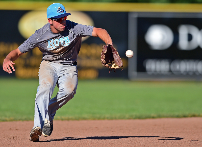 STRUTHERS, OHIO - JULY 7, 2018: Roth Brothers' Christian Gabriel field the ball before throwing to first for the out in the fourth inning of a baseball game against Baird Brothers, Saturday, July 7, 2018, in Struthers. DAVID DERMER | THE VINDICATOR