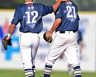 STRUTHERS, OHIO - JULY 7, 2018: Baird Brothers' Jacob McCaskey, right, gets a pat on the back by Josh Hoffman after turning a double play in the fifth inning of a baseball game against Roth Brothers, Saturday, July 7, 2018, in Struthers. DAVID DERMER | THE VINDICATOR