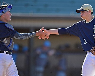 STRUTHERS, OHIO - JULY 7, 2018: Baird Brothers pitcher Marshall Mcgraw, right, is congratulated by catcher Dylan Swarmer after defeating Roth Bothers 2-0 in a baseball game, Saturday, July 7, 2018, in Struthers. DAVID DERMER | THE VINDICATOR