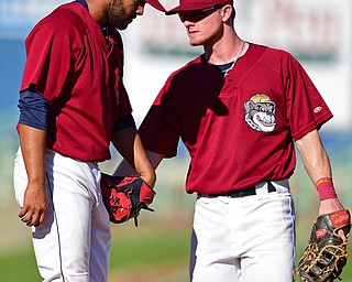 NILES, OHIO - JULY 8, 2018: Mahoning Valley Scrappers relief pitcher Luis Araujo, left, walks to the dugout after being relieved while getting a pat on the back from Mitch Reeves in the eighth inning of a baseball game against the Williamsport Crosscutters, Sunday, July 8, 2018, in Niles. The Crosscutters won 8-4. DAVID DERMER | THE VINDICATOR