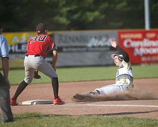 Baird Brothers' Andrew Russell slides into third while Knightline's Anthony Cinicola waits for the ball during the Class B tournament game on Tuesday.