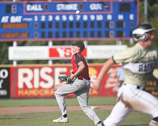 Knightline's Adam Jannette turns as the ball goes over his head while Baird Brothers' Andrew Russell runs home during the Class B tournament game on Tuesday.