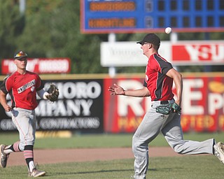 Knightline's Adam Jannette misses the ball and Kole Klasic runs in for back-up during the Class B tournament game against Baird Brothers on Tuesday.