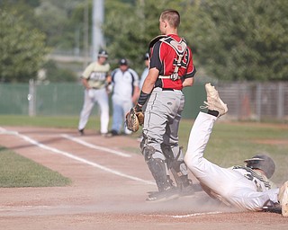 Baird Brothers' Coleman Stauffer slides into home and scores in the third inning of the Class B tournament game against Knightline on Tuesday.