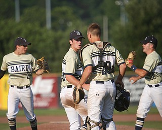 Baird Brothers' Jacob McCaskey, far left, and Dylan Swarmer, far right, run off the field while Andrew Russel and Coleman Stauffer talk after holding Knightlife 2-0 at the end of the fourth inning of the Class B tournament game against Knightline on Tuesday.