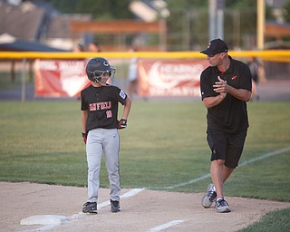 Canfield's Drew Snyder smiles after hitting the ball during the Little League baseball 11-U playoff game against Boardman on Wednesday.