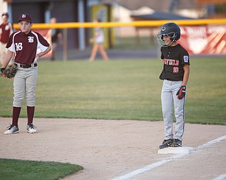 Canfield's Drew Snyder smiles after hitting the ball during the Little League baseball 11-U playoff game against Boardman on Wednesday.