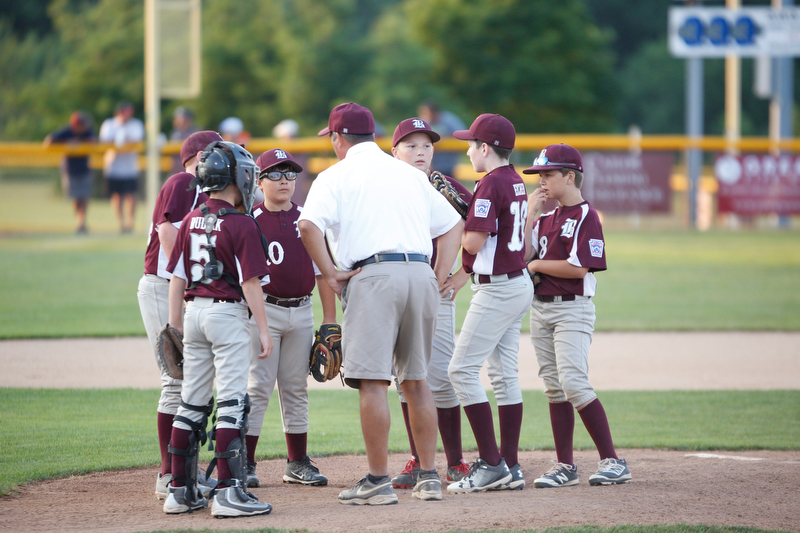 Boardman's infield huddles after Canfield scores two runs in the first inning of the Little League baseball 11-U playoff game on Wednesday.