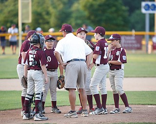 Boardman's infield huddles after Canfield scores two runs in the first inning of the Little League baseball 11-U playoff game on Wednesday.