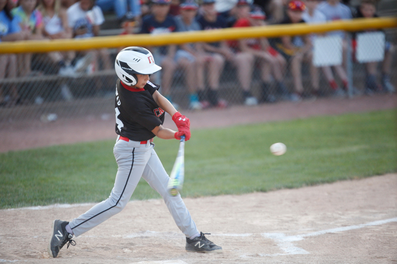 Canfield's Jake Bednar hits the ball during the Little League baseball 11-U playoff game against Boardman on Wednesday.