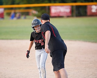 Canfield's Drew Snyder smiles after getting to first during the Little League baseball 11-U playoff game against Boardman on Wednesday.