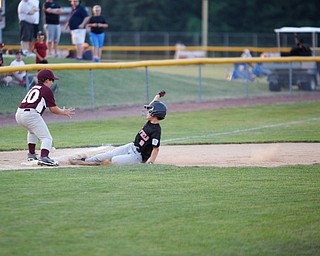 Canfield's Drew Snyder slides safely into third during the Little League baseball 11-U playoff game against Boardman on Wednesday.