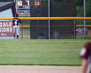 Boardman's Mike Demetrios watches the ball, hit by Canfield's Dylan Mancini, go over the fence during the Little League baseball 11-U playoff game on Wednesday.