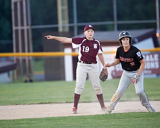 Boardman's Mason Nawrocki points to third as Canfield's Angelo Delucia takes a lead during the Little League baseball 11-U playoff game on Wednesday.