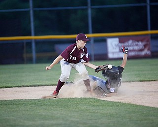 Boardman's Mason Nawrocki misses the throw from home as Canfield's Drew Snyder slides into second during the Little League baseball 11-U playoff game on Wednesday.