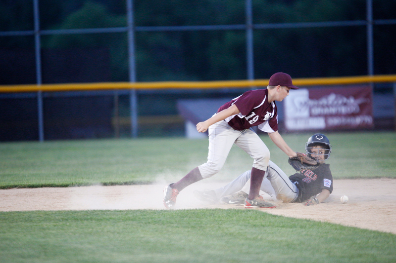 Boardman's Mason Nawrocki misses the throw from home as Canfield's Drew Snyder slides into second during the Little League baseball 11-U playoff game on Wednesday.