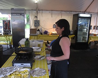 Neighbors | Zack Shively.St. John's festival featured food hand-made from church members. They had a dining hall inside with many types of food as well as tents outside with food vendors selling Greek dinners. Pictured, Chryse Ellinos cooked up saganaki, a fried cheese appetizer.