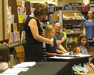 Neighbors | Zack Shively.The fourth-grade students from Robinwood Lane Elementary gave their name, the title of their book and a brief description of the story during their presentations. Then, they talked about themselves as authors and read a section of the story. Pictured, Mary Malone presented on her book "The Flashcard."