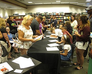 Neighbors | Zack Shively.Rovinwood Lane's fourth-grade students gave out autographs after doing their presentation at Barnes and Noble. The families at the event spoke to the students about their stories and illustrations.