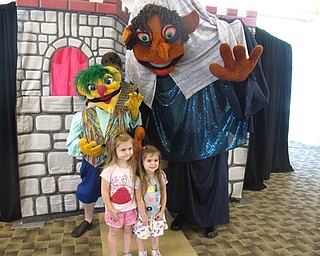 Neighbors | Zack Shively.The Madcap Puppets presented a retelling of Rumpelstiltskin for families at the Austintown library on June 13. The performers used a number of puppets for charcters throughout the play. Pictured, children Randi and Audrey Thomas posed for photos with Rumpelstiltskin and the Crazy Lady after the performance.