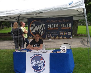 Neighbors | Jessica Harker .Jake Capezzuto, an intern at The Summit radio station, ran the booth at the first concert of the Live! at the Morley series on June 20.