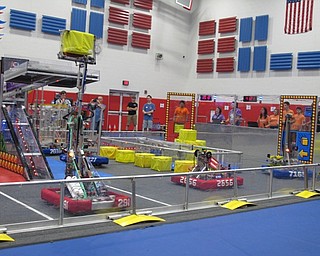 Neighbors | Jessica Harker.Robots controlled by members of both the red and blue alliance drove around the arena during one round of the Austintown robotics tournament June 30 at Austintown Middle School.