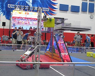 Neighbors | Jessica Harker.The robot of one of the winning teams, Delphi E.L.I.T.E. from Warren, hoisted one of the yellow blocks onto their side of the scale on June 30 during the Austintown robotics tournament.