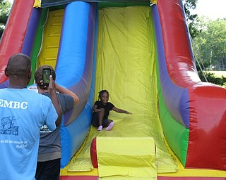 Neighbors | Jessica Harker.Alexis Newell, age 4, slid down the bounce house slide on June 30 at the Boardman Family Night in the park event.