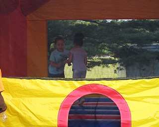 Neighbors | Jessica Harker.Zaiquan Rollins and his sister Lyhilla John jumped in one of the bounce houses at the Boardman Park Family Night event on June 30.