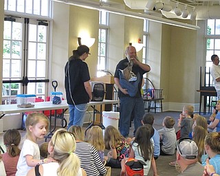 Neighbors | Jessica Harker.Beth Felger held a baby marmoset monkey while Dwayne Felger held the baby kangaroo at the June 28 Felgers exotic animals presentation at the Poland library.