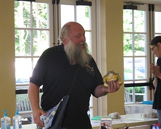 Neighbors | Jessica Harker.Dwayne Felger held a pixie toad as he explained information about the animal at the Poland library on June 28.