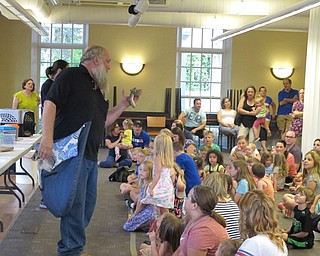 Neighbors | Jessica Harker.Dwayne Felger held a ball python as he presented to the children gathered at the Poland library June 28.