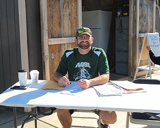 Neighbors | Jessica Harker.Jason Montgomery, president of the AGSL, sat at the registration table July 7 to kick start the Jessica Morehead memorial tournament at Austintown Park.