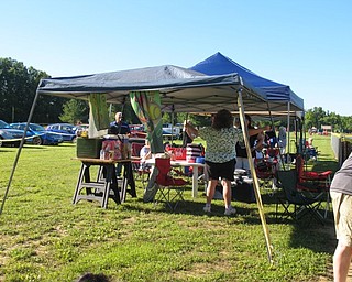 Neighbors | Jessica Harker.Parents and family members of players set up tents with drink stations for the girls and healthy snacks during the AGSL Jessica Morehead memorial softball team tournament.