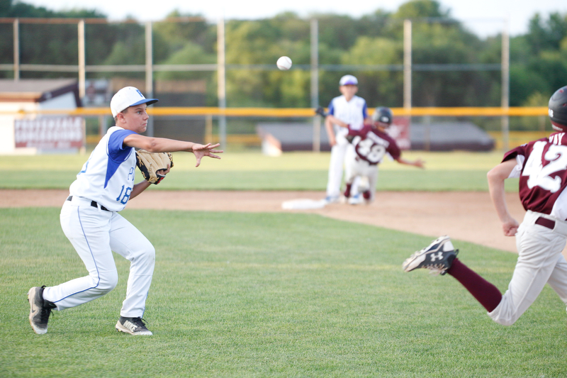 Poland's Matt Paparoois throws the ball to first to get Boardman's Matt Kay out during the 12u district championship game at Field of Dreams in Boardman on Thursday.