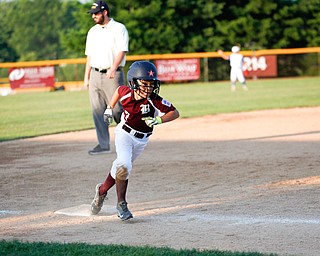 Boardman's Nate Adams rounds third during the 10u championship game against Poland at Field of Dreams on Friday. Boardman won 13-10.