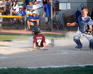 Boardman's Nate Adams slides safely into home during the 10u championship game against Poland at Field of Dreams on Friday. Boardman won 13-10.