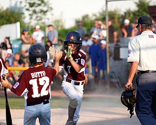 Boardman's Nate Adams high-fives Vincent Butto during the 10u championship game against Poland at Field of Dreams on Friday. Boardman won 13-10.