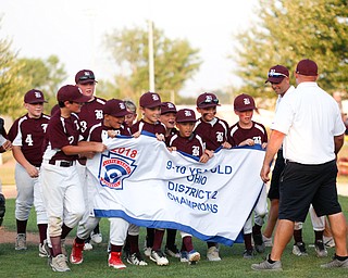 Boardman's 10u team holds their banner after winning the district championship game against Poland 13-10.