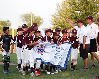 Boardman's 10u team holds their banner after winning the district championship game against Poland 13-10.