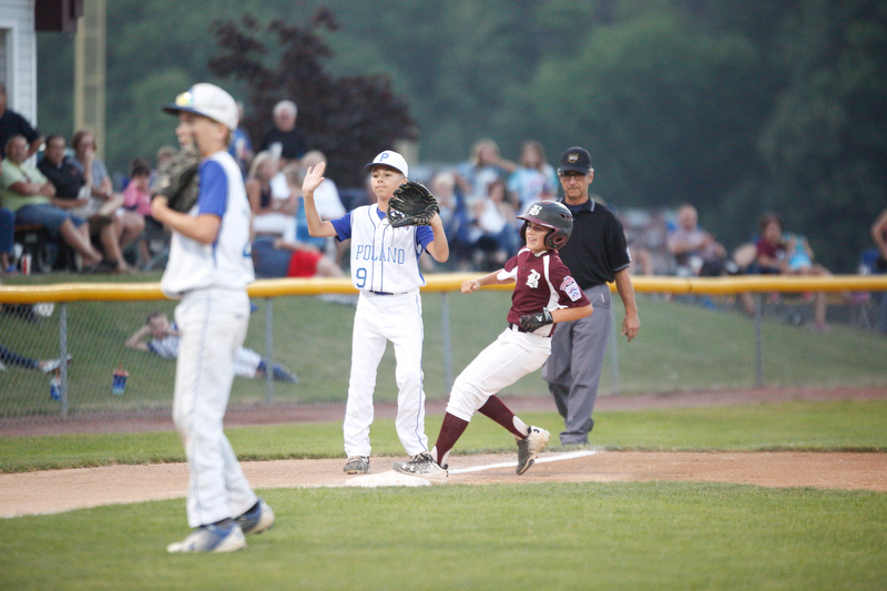 Boardman's Marty Stackowitz makes it to third while Poland's Ryan DiLulla waits for the ball during the 12u championship game at Field of Dreams on Friday.