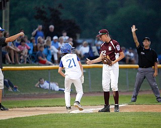 Boardman's Jack Ericson asks Poland's Danny Nitolli if he's okay after Nitolli dove into third during the 12u championship game at Field of Dreams on Friday.