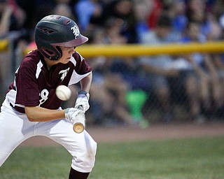 Boardman's Cal Huston bunts the ball during the 12u championship game against Poland at Field of Dreams on Friday.