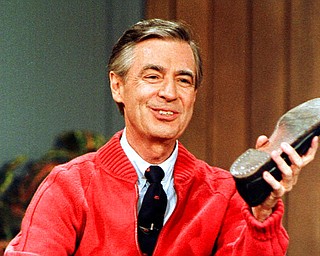 FILE - This June 28, 1989, file photo, shows Fred Rogers as he rehearses the opening of his PBS show "Mister Rogers' Neighborhood" during a taping in Pittsburgh. A new Fred Rogers Trail promoted by VisitPA.com includes museums, memorials and other sites. This year marks the 50th anniversary of "Mister Rogers' Neighborhood" and a new documentary called "Won't You Be My Neighbor?" has helped rekindle interest in his legacy. (AP Photo/Gene J. Puskar, File)