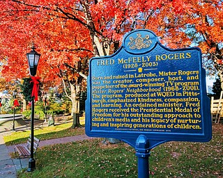 This photo provided by the Laurel Highlands Visitors Bureau shows a marker memorializing Fred Rogers, host of the old PBS children's television show "Mister Rogers' Neighborhood" in his hometown of Latrobe, Pa. The marker is in James H. Rogers Memorial Park, named for Fred Rogers' father. Latrobe is about 40 miles from Pittsburgh, where the show was filmed. Both cities are on the Fred Rogers Trail being promoted by Pennsylvania tourism. This year marks 50 years since "Mister Rogers' Neighborhood" first aired. A new documentary called "Won't You Be My Neighbor?" has rekindled interest in Rogers' legacy. (Laurel Highlands Visitors Bureau via AP)
