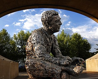 FILE - This Sept. 4, 2015, file photo, shows a statue of Mr. Fred Rogers at the Mr. Rogers Memorial on the Northside of Pittsburgh. A new Fred Rogers Trail promoted by VisitPA.com includes the sculpture along with museums and other sites. This year marks the 50th anniversary of "Mister Rogers' Neighborhood" and a new documentary called "Won't You Be My Neighbor?" has helped rekindle interest in his legacy.(AP Photo/Gene J. Puskar, File)