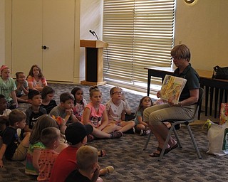 Neighbors | Jessica Harker.Peg Flynn, green team member, read "From Trash to Treasure," to a group of children on June 25 at the Austintown library.