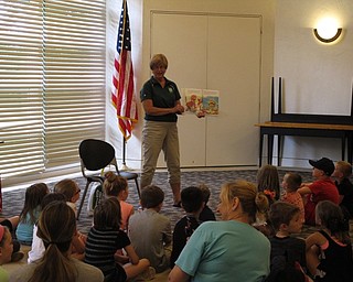 Neighbors | Jessica Harker.Peg Flynn, green team member, read "From Trash to Treasure," to a group of children on June 25 at the Austintown library.