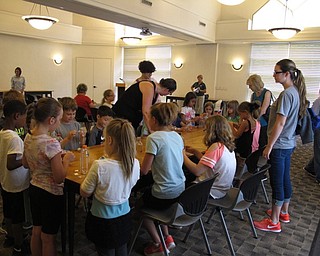 Neighbors | Jessica Harker.A large group of children gathered around a table to create their musical shakers at the June 25 Rock Out with the Green Team event.